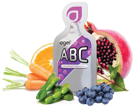 Agel ABC 'Children's Essentials' pouch surrounded by orange, pomegranate, carrots, soybeans, and blueberries